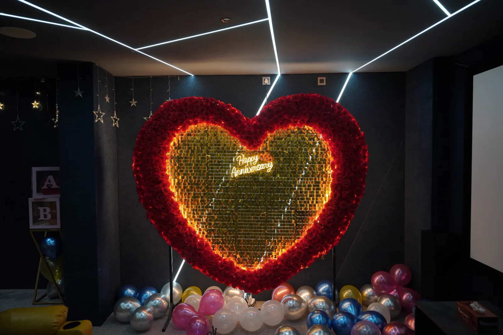 Sample anniversary decoration inside a dark private theatre with linear ceiling lights