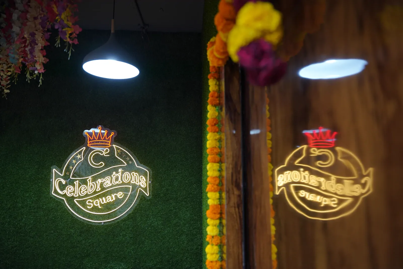 Sample private theatre venue entrance with floral decoration, pendant lights and illuminated signage